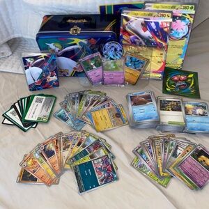 Pokémon TCG cards and lunch box. Includes holographic cards and promo cards